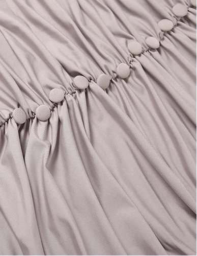 Close-up of a light gray fabric with button details