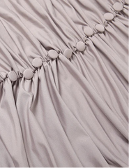 Close-up of a light gray fabric with button details