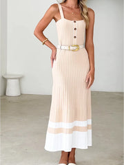 Woman wearing a beige and white dress with a belt in a minimalistic setting
