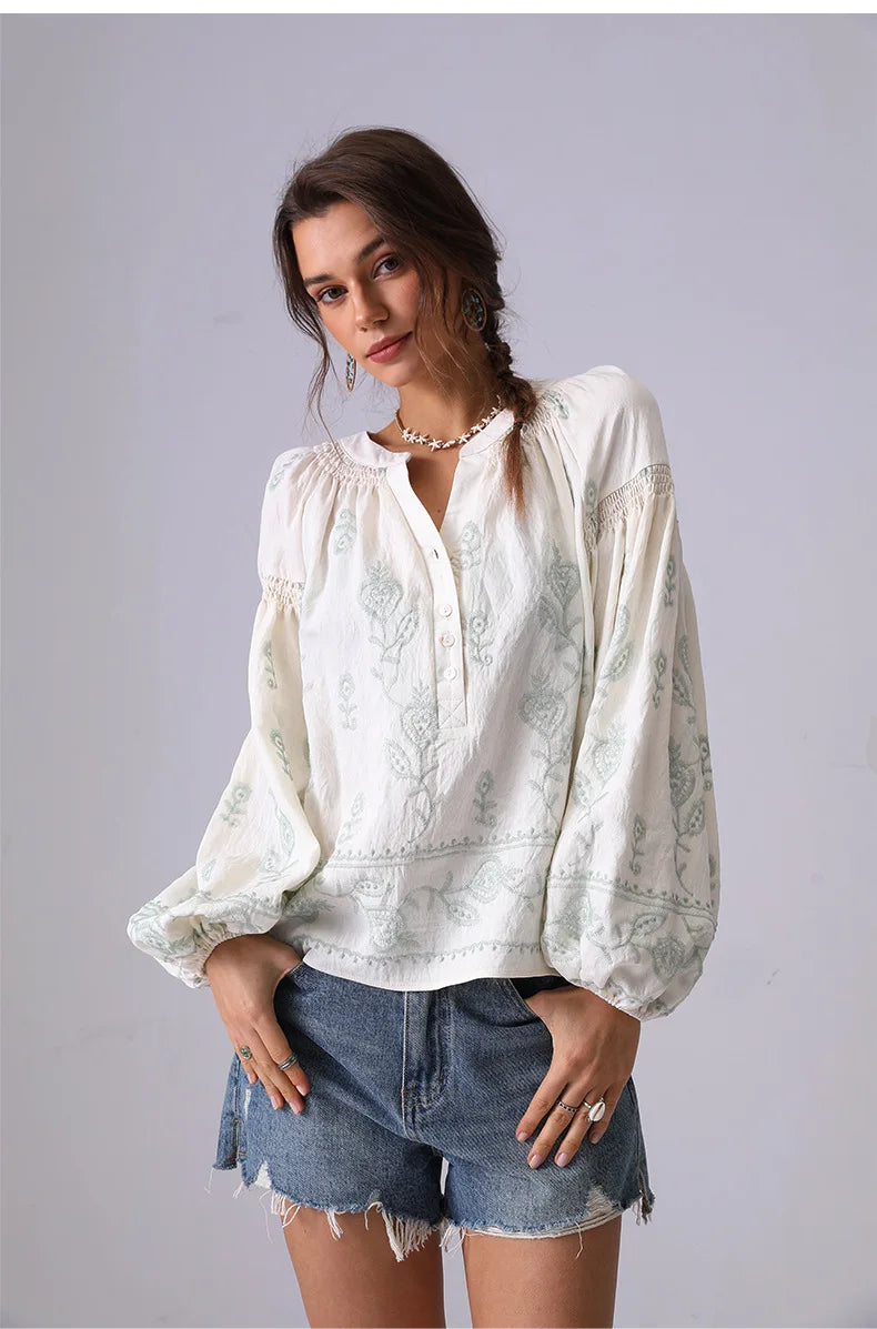 Model wearing a white cotton blouse with lantern sleeves