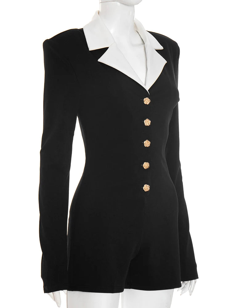 Black dress with white collar and gold buttons on a mannequin against a white background