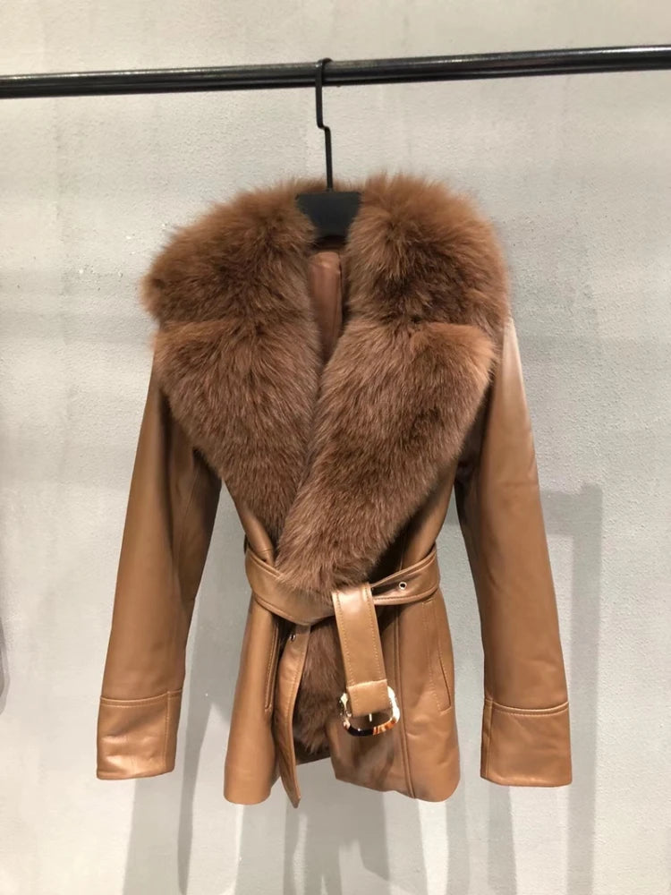 Brown leather jacket with fur collar on a hanger against a light gray background
