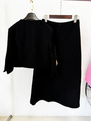 Back view of beaded cropped jacket and midi skirt suit