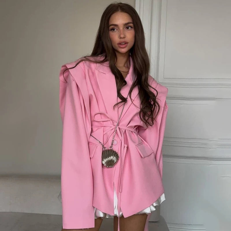 Woman wearing a pink coat with a neutral background