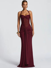 Burgundy evening gown on a model against a light gray background