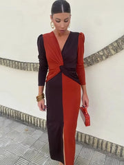 Woman wearing a red and black dress with a white wall background