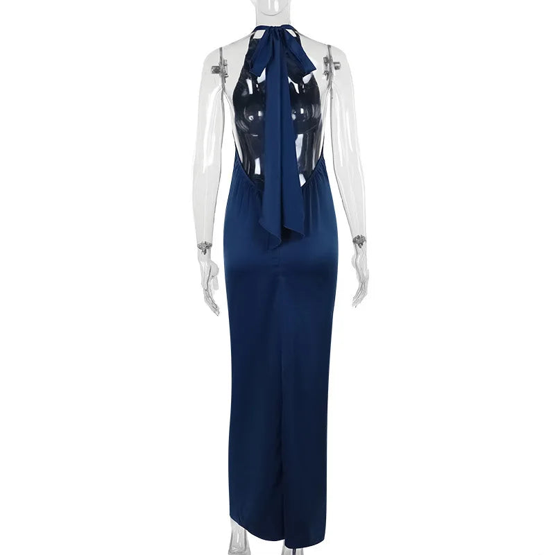 Navy blue jumpsuit with a sheer overlay on a mannequin against a white background