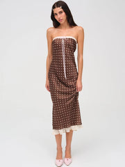 Woman wearing strapless brown polka dot midi dress