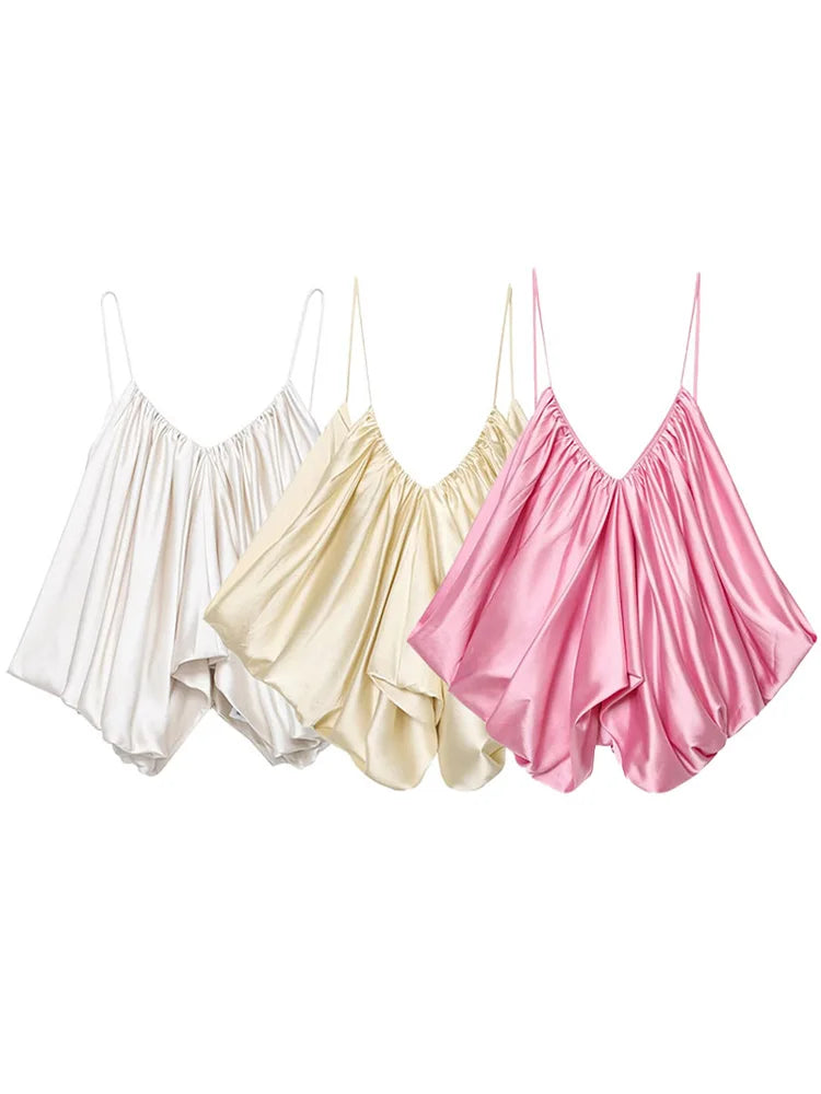 Three satin camisoles in white, beige, and pink