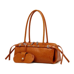 Brown leather handbag with matching pouch on a white background