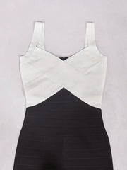 Black and white dress with criss-cross straps on a light gray background