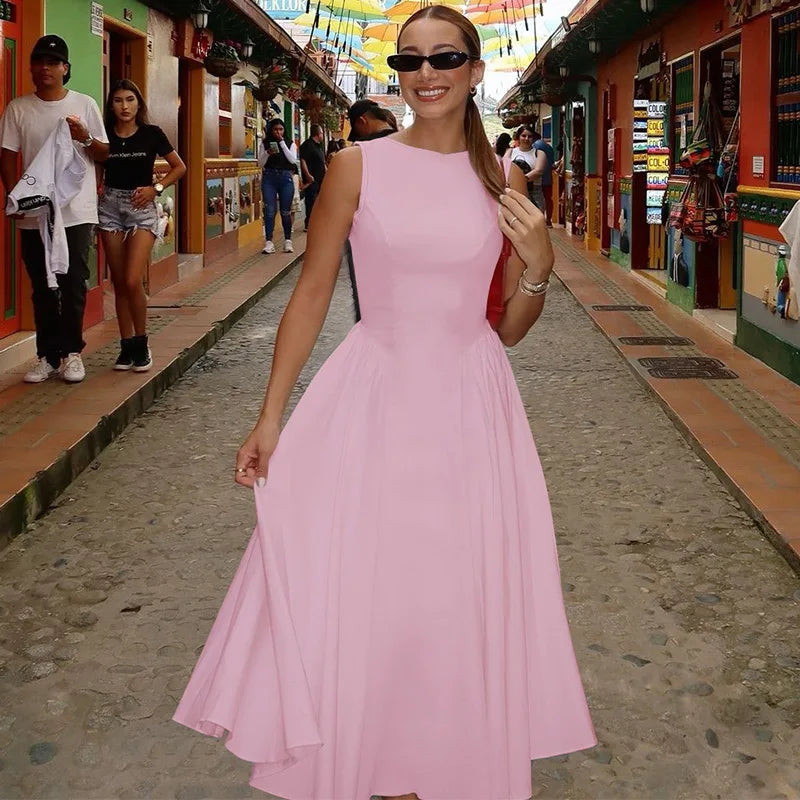 Woman in a pink dress walking on a street with colorful shops.