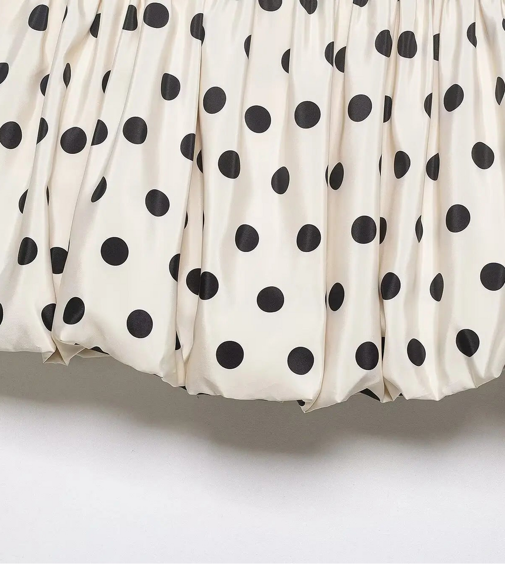 White skirt with black polka dots on a white background
