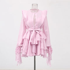 Pink ruffled blouse on a mannequin against a white background