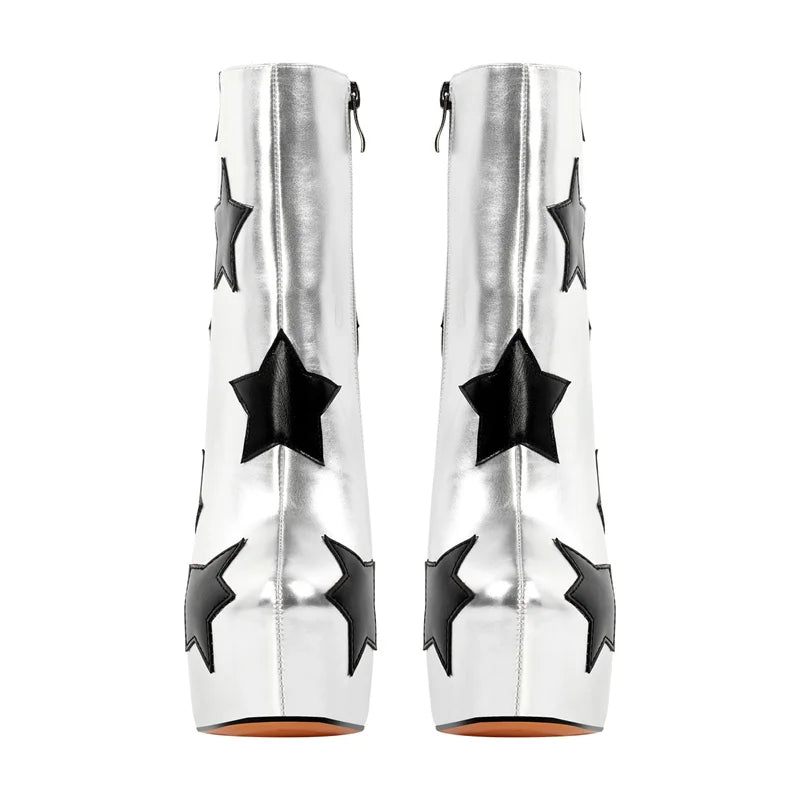 White high-heeled boots with black star patterns on a white background