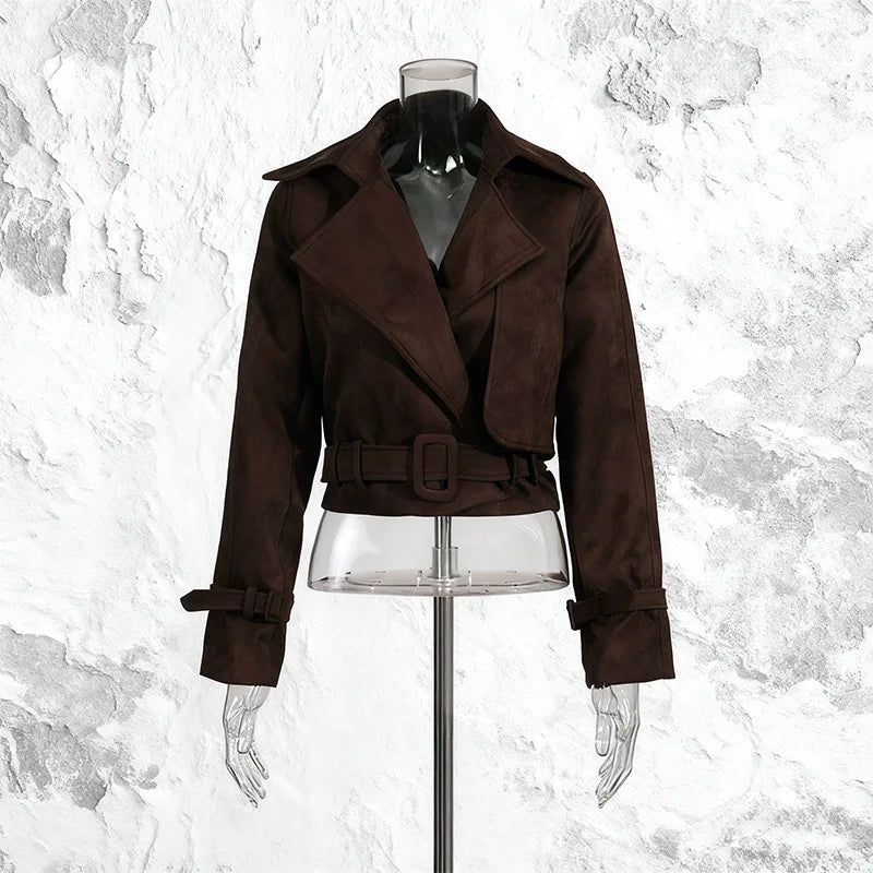 Brown jacket on a mannequin against a textured white background