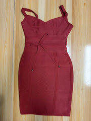 Red dress with thin straps on a wooden surface