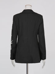 Black blazer on a mannequin against a white background