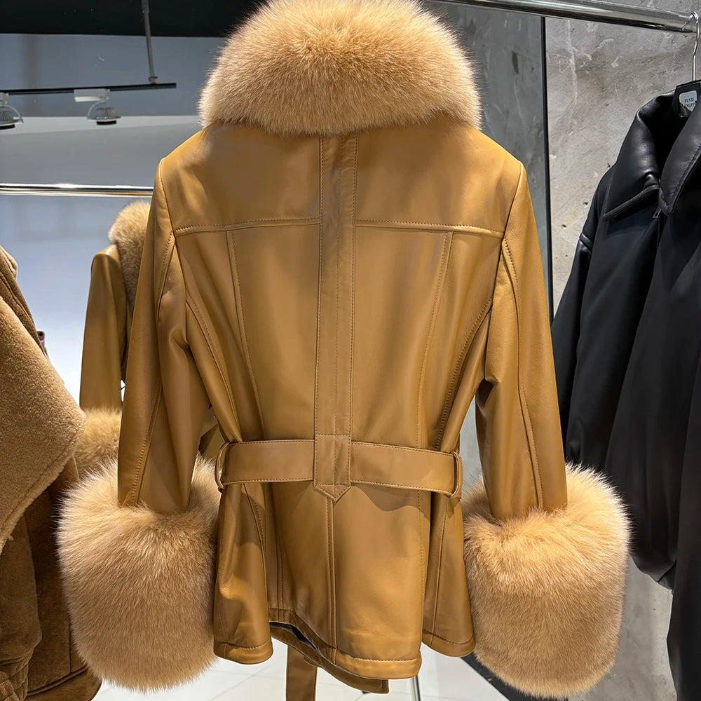Beige coat with fur trim hanging on a rack.
