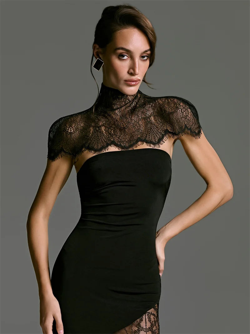 Woman wearing a black lace dress against a gray background