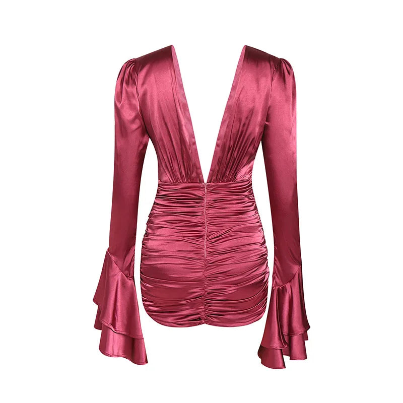 Pink satin dress with ruched details on a white background