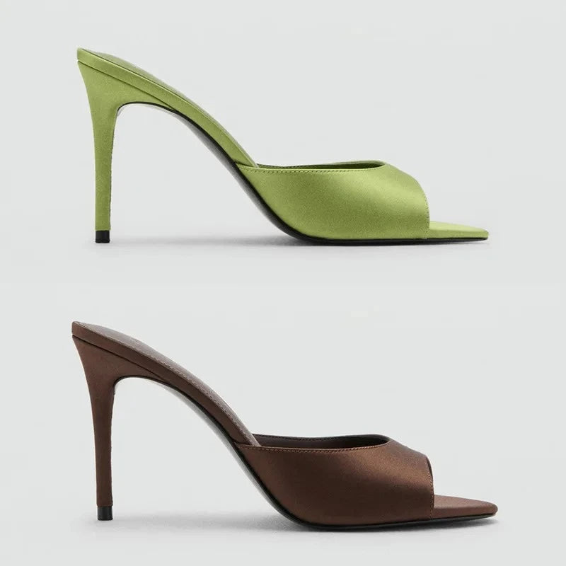 Side profile of green and brown satin stiletto heel mules