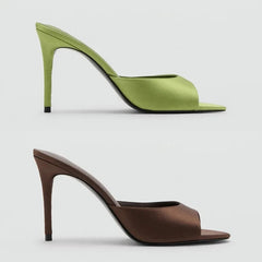 Side profile of green and brown satin stiletto heel mules
