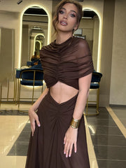 Woman wearing a brown outfit in an elegant interior setting