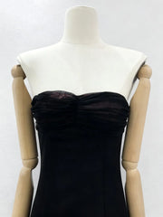 Black dress on a mannequin against a white background