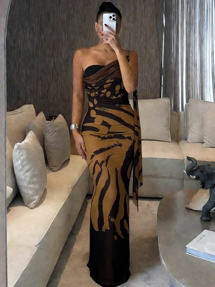 Person wearing a black and gold dress in a modern living room.