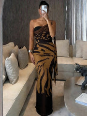 Person wearing a black and gold dress in a modern living room.