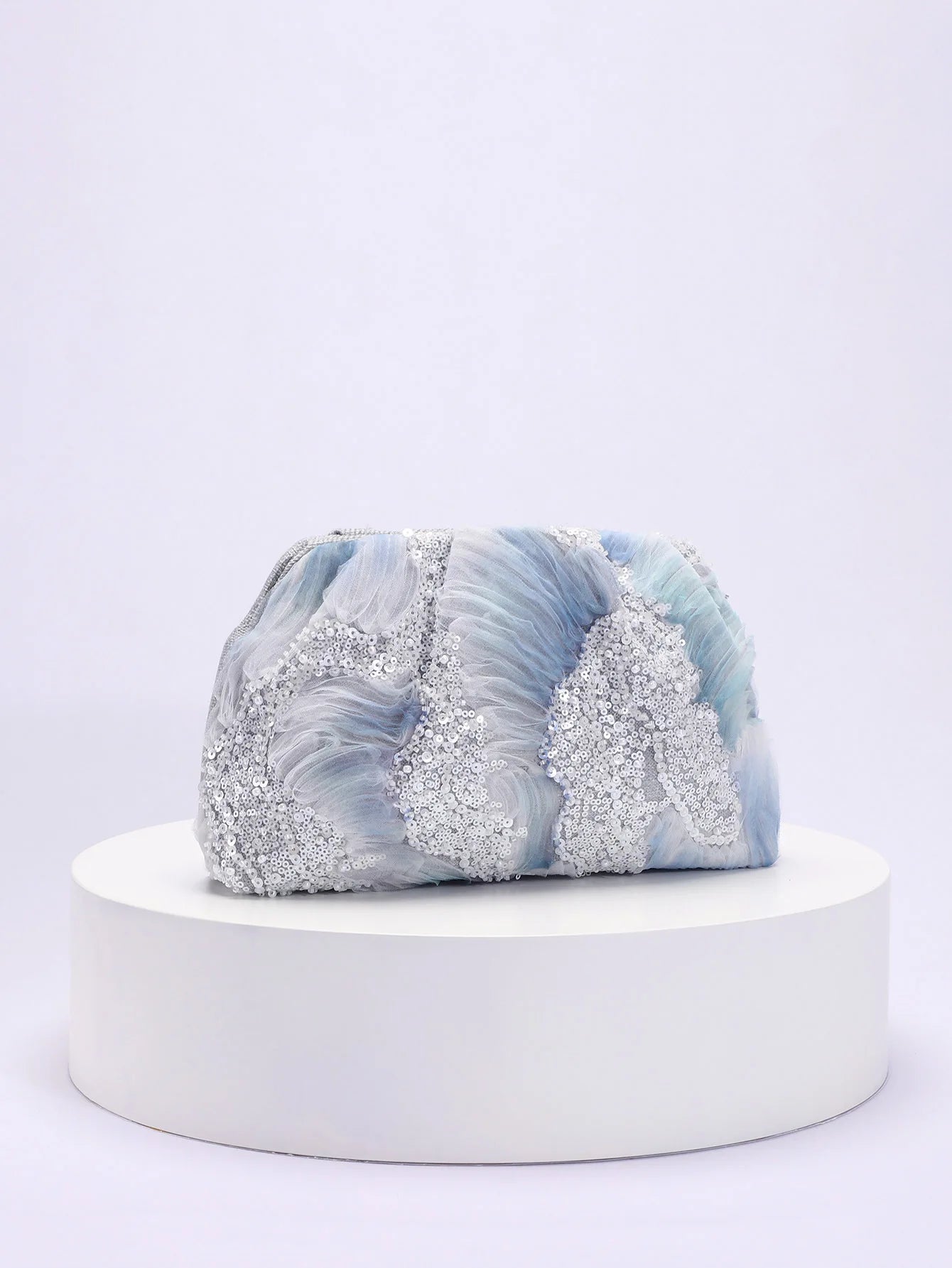 Marble-patterned product on a white pedestal with a light gray background