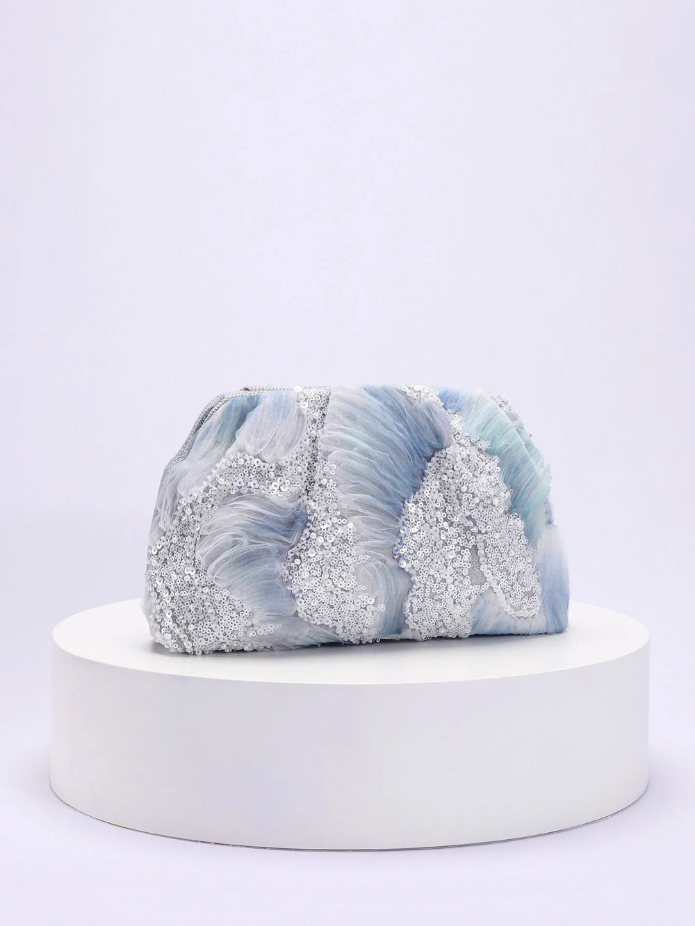 Marble-patterned product on a white pedestal with a light gray background