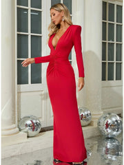 Woman wearing a red evening gown in an elegant indoor setting with disco balls.
