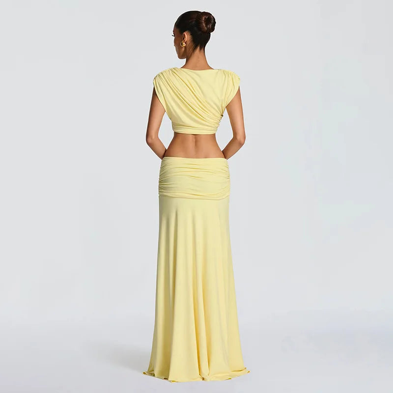 Woman wearing a yellow outfit with a plain background