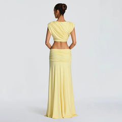 Woman wearing a yellow outfit with a plain background