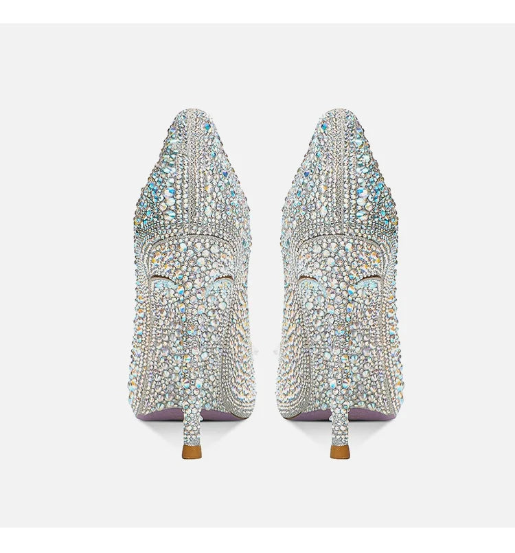 Pair of embellished high-heeled shoes on a white background