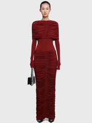 Model wearing a burgundy ruched dress on a white background