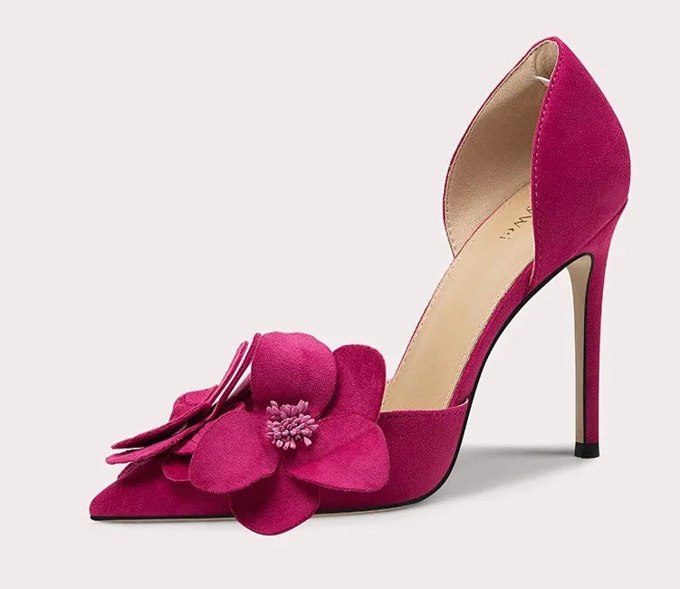 Pink high-heeled shoe with floral design on a light gray background