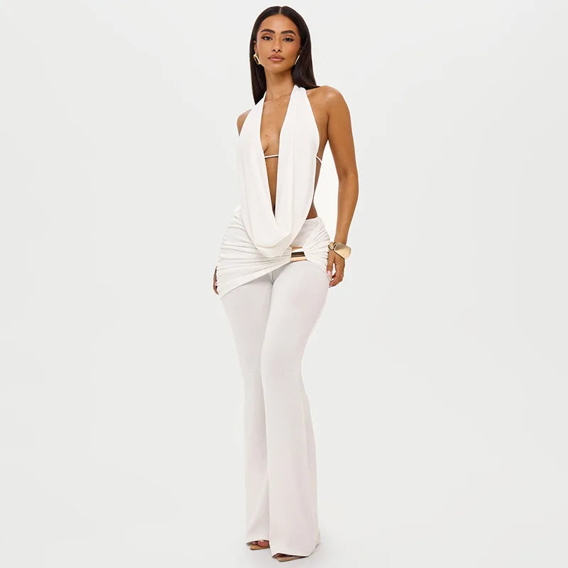 Woman wearing a white outfit on a plain background