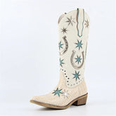 White cowboy boot with star and horseshoe patterns on a light gray background