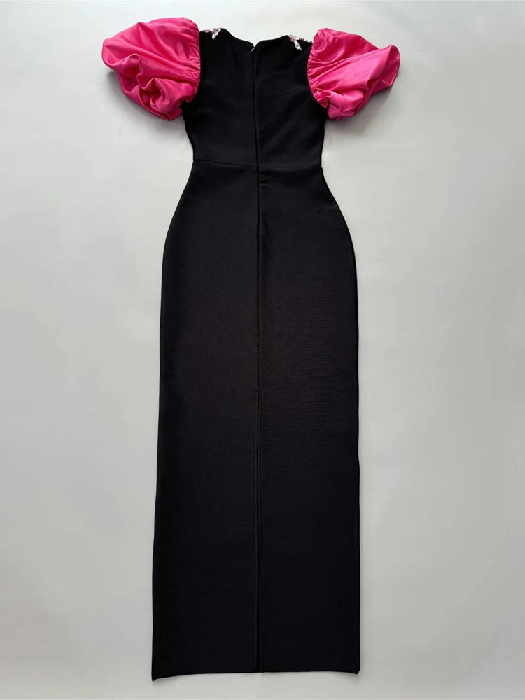 Black dress with pink ruffled sleeves on a light gray background