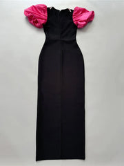 Black dress with pink ruffled sleeves on a light gray background