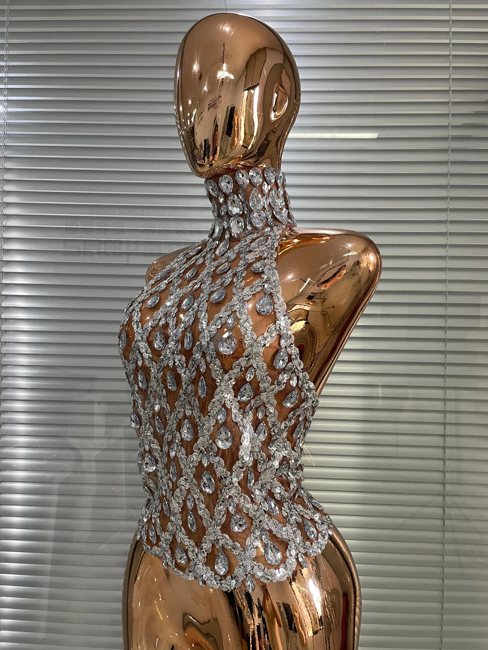 Side view of sparkling mesh halter neck top in rose gold.
