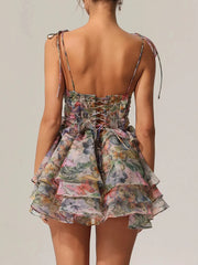 Floral tiered dress with thin straps on a plain background