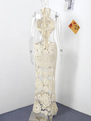 White lace dress on a mannequin against a white wall with a blue floor.