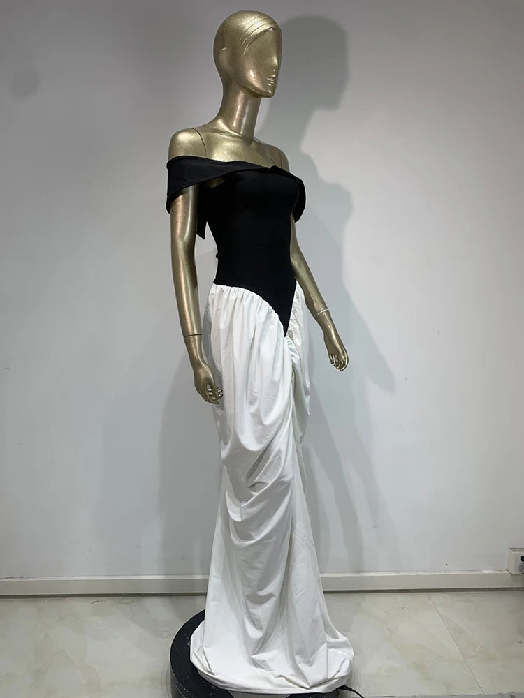 Mannequin wearing a black top and white skirt against a plain background