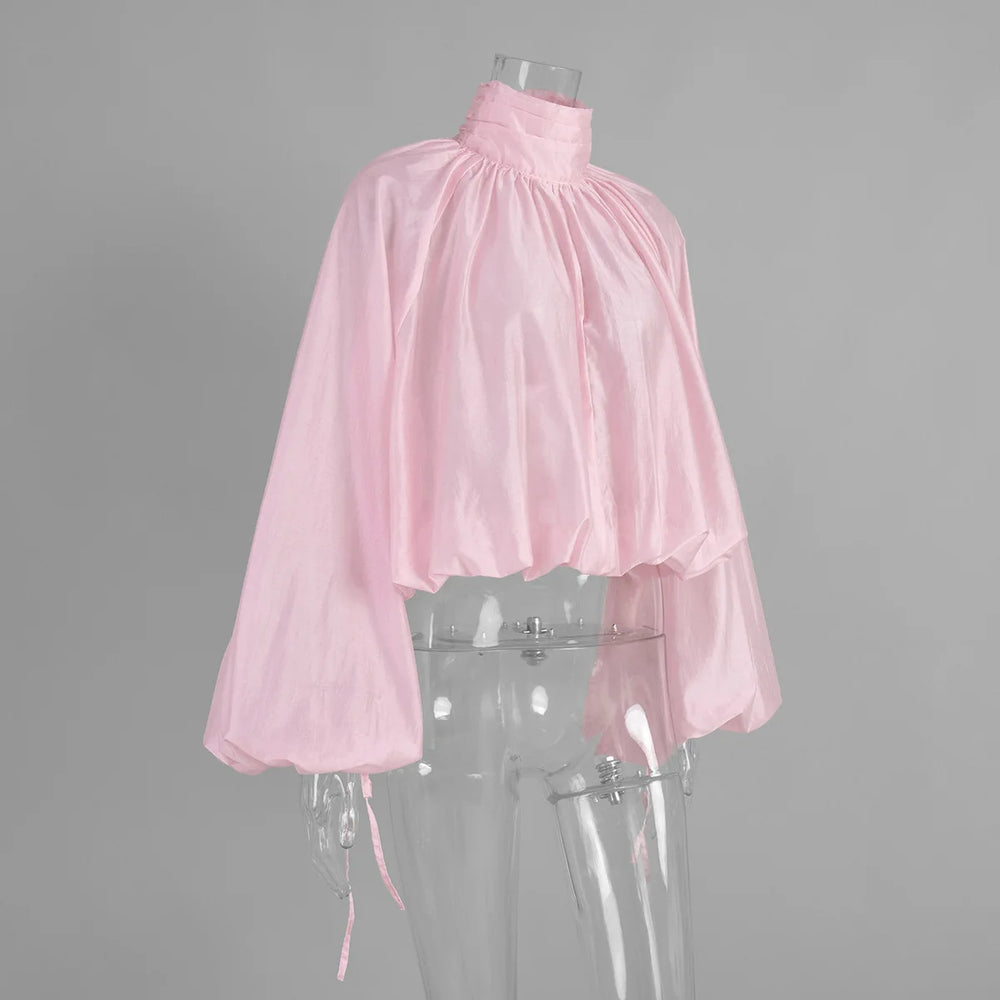 Pink blouse on a transparent mannequin against a gray background