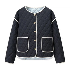 Navy quilted jacket with white accents on a white background
