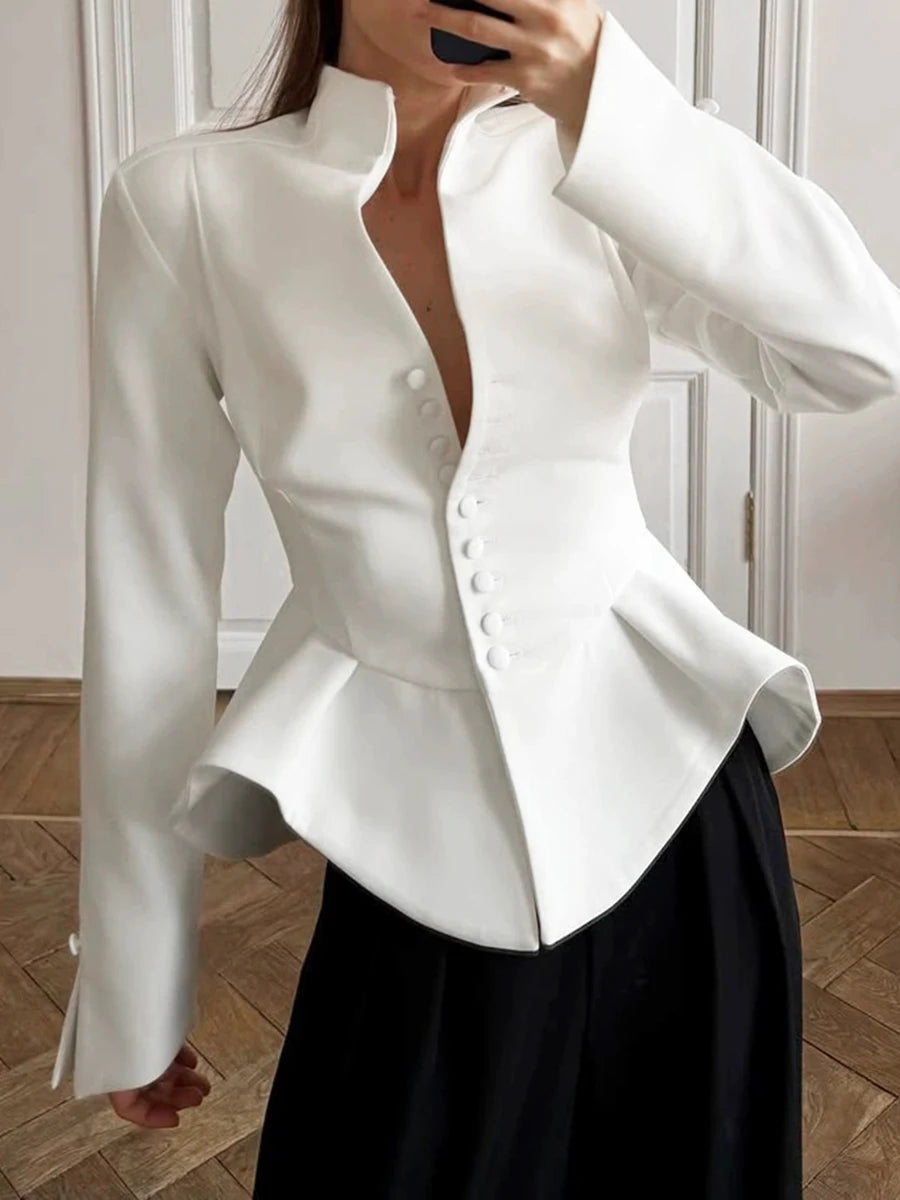 Close-up of the stand collar and button detail on a peplum jacket